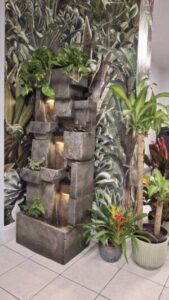 Calming waterfall feature and tropical decor inside Studio 50 Salon in Middletown NY creating a relaxing salon atmosphere